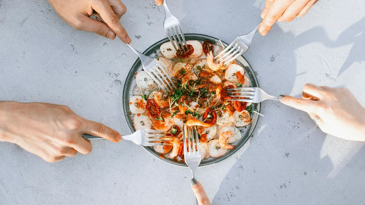 A bubbling Mexican seafood molcajete filled with shrimp, octopus, and cactus.